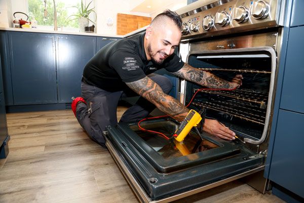 Hometown Hero repairing an oven in Des Moines